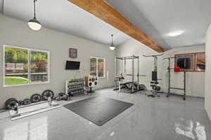 Workout room with vaulted ceiling