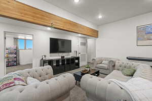 Carpeted living room with recessed lighting and baseboards
