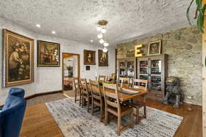 Dining space with wood-type flooring, baseboards, and recessed lighting