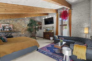 Carpeted bedroom with a fireplace