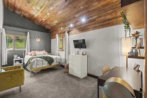 Carpeted bedroom featuring wooden ceiling and lofted ceiling