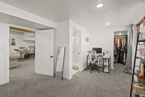 Home office with carpet floors, a textured ceiling, baseboards, and recessed lighting