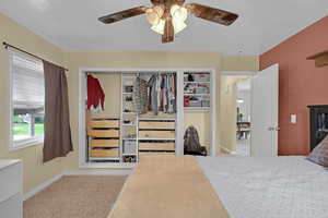 Bedroom with carpet flooring, baseboards, and a ceiling fan