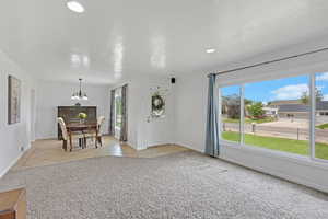 Dining room featuring a chandelier, plenty of natural light, baseboards, light tile patterned floors, and recessed lighting