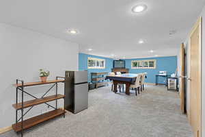 Recreation room featuring carpet floors, recessed lighting, a fireplace, and baseboards