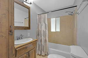 Full bath with toilet, vanity, shower / tub combo with curtain, and tile patterned floors