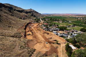 Aerial view of property and surrounding area with a mountain backdrop