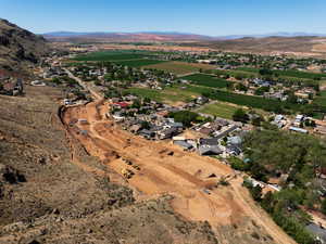 Aerial view of property and surrounding area featuring a mountainous background