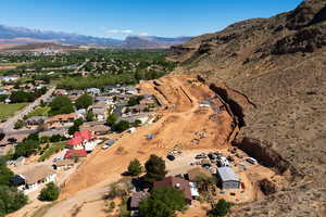 Aerial view of property and surrounding area with mountains and nearby suburban area