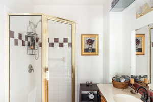 Full bathroom with vanity and a shower stall