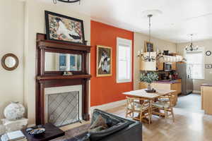 Dining room with light wood finished floors, baseboards, and a chandelier