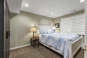 Carpeted bedroom featuring baseboards and recessed lighting