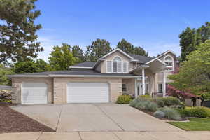View of front of house with concrete driveway, an attached garage, brick siding, and roof with shingles