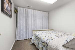 Carpeted bedroom featuring baseboards