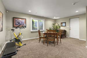 Carpeted dining area with baseboards and recessed lighting