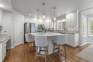 Kitchen featuring stainless steel appliances, baseboards, a sink, plenty of natural light, and recessed lighting