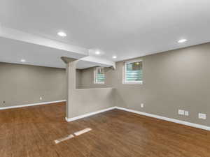 Below grade area featuring baseboards, wood finished floors, and recessed lighting