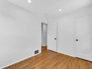 Unfurnished bedroom featuring light wood-style flooring, baseboards, and recessed lighting