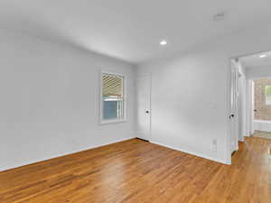 Spare room with ornamental molding, light wood finished floors, a smoke detector, recessed lighting, and baseboards