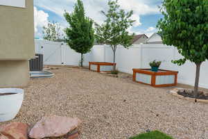 Fenced yard with a gate and central AC unit