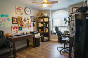 Office area featuring ceiling fan, wood finished floors, and baseboards
