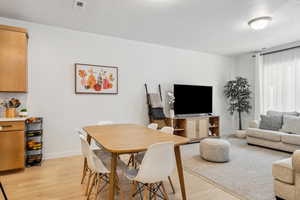 Dining area featuring light wood-style floors and baseboards