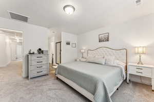 Bedroom with light colored carpet