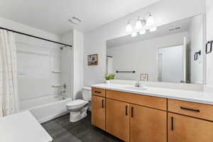 Full bath featuring vanity, tile patterned flooring, toilet, and shower / tub combo with curtain