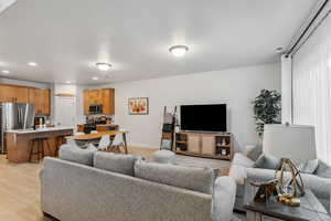 Living room featuring light wood-style floors, recessed lighting, and baseboards