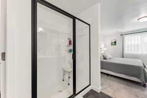 Ensuite bathroom featuring a shower stall