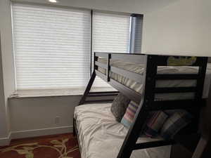 Bedroom with baseboards and wood finished floors