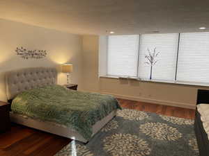 Bedroom featuring wood finished floors and baseboards