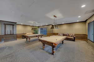 Rec room featuring billiards table, wallpapered walls, carpet, wainscoting, and crown molding