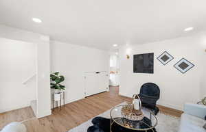 Living area featuring light wood-type flooring, recessed lighting, and baseboards