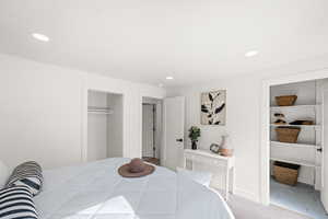 Bedroom featuring a closet, recessed lighting, carpet flooring, and baseboards