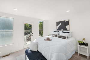 Carpeted bedroom with access to outside and recessed lighting