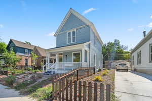 View of front of house with covered porch and concrete driveway