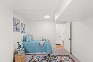 Carpeted bedroom featuring baseboards