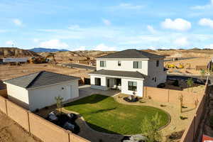 Rear view of house with a mountain view, stucco siding, and a patio