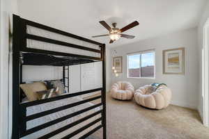 Bedroom with carpet flooring, baseboards, and ceiling fan