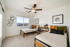 Bedroom with baseboards, carpet floors, a ceiling fan, and a closet