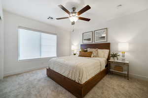 Carpeted bedroom with baseboards and ceiling fan