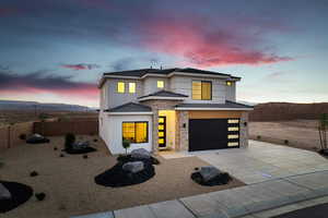 View of front of home featuring stone siding, an attached garage, stucco siding, concrete driveway, and a tiled roof