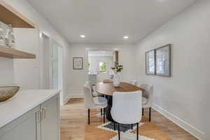 Dining room with recessed lighting, light wood-style flooring, and baseboards