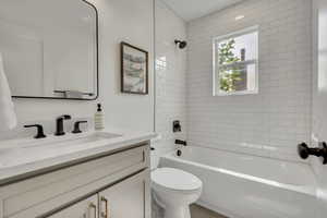 Full bath with vanity, toilet, and shower / bathtub combination