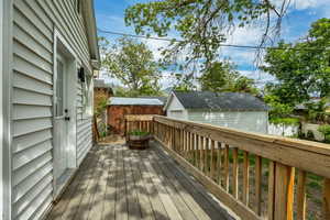 Wooden terrace with a detached garage and an outdoor structure