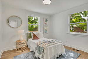 Bedroom featuring baseboards and wood finished floors
