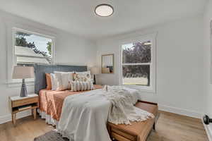 Bedroom featuring light wood finished floors and baseboards