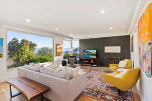 Living area featuring recessed lighting, wood finished floors, and baseboards