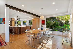 Dining room featuring light wood finished floors, recessed lighting, beamed ceiling, and baseboards